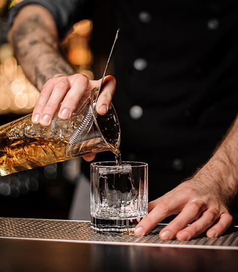 Land Run Distillery's premium whiskey being poured - supporting local jobs and economic development in Newkirk, Oklahoma