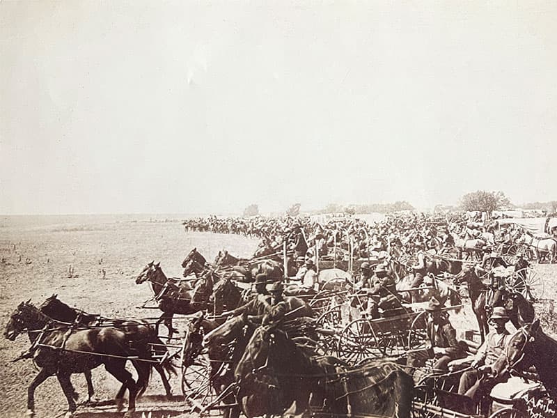 Historical photo of the 1893 Land Run in Oklahoma, showcasing the pioneering spirit behind Land Run Distillery